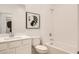 Bright white bathroom featuring a tub-shower combination and modern vanity with a framed monstera print at 242 White Crest Peak Ave, Henderson, NV 89015