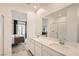 Luxurious bathroom featuring a double vanity, modern fixtures, and a glass-enclosed shower, with a glimpse into the bedroom at 242 White Crest Peak Ave, Henderson, NV 89015