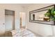 This bedroom features a unique decorative mirror, an adjacent closet, and views into the hallway at 242 White Crest Peak Ave, Henderson, NV 89015