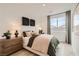 Cozy bedroom featuring a queen bed, neutral decor, and plenty of natural light at 242 White Crest Peak Ave, Henderson, NV 89015