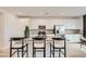 Contemporary kitchen features a central island, stainless appliances, and sleek cabinetry at 242 White Crest Peak Ave, Henderson, NV 89015