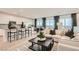 Open-concept living area featuring modern decor, a kitchen island, and lots of natural light at 242 White Crest Peak Ave, Henderson, NV 89015