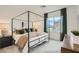 Inviting main bedroom with a four-poster bed, plush bedding, neutral decor, and a view of the outdoors at 242 White Crest Peak Ave, Henderson, NV 89015