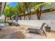 Outdoor living space with a patio, mature landscaping and a lounge chair for relaxation at 2513 Aberdeen Ln, Henderson, NV 89014