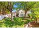 A backyard with a green lawn, shade trees and a patio perfect for entertaining at 2513 Aberdeen Ln, Henderson, NV 89014