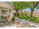 Charming backyard featuring a small patio, green grass, mature shade trees and a swing set at 2513 Aberdeen Ln, Henderson, NV 89014