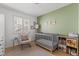 Cozy Bedroom featuring a crib, rocking chair, and colorful decor at 2513 Aberdeen Ln, Henderson, NV 89014
