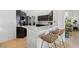 Modern kitchen featuring stylish counter seating, black cabinets, and marble countertops at 2513 Aberdeen Ln, Henderson, NV 89014