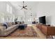 Spacious living room with large windows, wood floors, a ceiling fan and comfortable, stylish furniture at 2513 Aberdeen Ln, Henderson, NV 89014