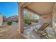 Charming backyard with patio, lounge chair, desert landscaping, and privacy wall at 2613 Velodrome Ct, Henderson, NV 89044