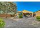 Low-maintenance backyard featuring desert landscaping, mature trees, and privacy fence at 2613 Velodrome Ct, Henderson, NV 89044
