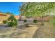 Low-maintenance backyard features gravel and select trees/foliage creating a serene and desert-friendly outdoor space at 2613 Velodrome Ct, Henderson, NV 89044