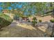 The expansive backyard boasts low-maintenance landscaping with gravel and mature trees providing shade at 2613 Velodrome Ct, Henderson, NV 89044