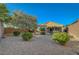 Low-maintenance backyard featuring desert landscaping, mature trees, and privacy fence at 2613 Velodrome Ct, Henderson, NV 89044