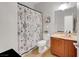 A functional bathroom featuring a modern vanity, toilet, and decorative shower curtain at 2613 Velodrome Ct, Henderson, NV 89044