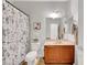Functional bathroom with a shower curtain, vanity, and a mirror for daily grooming needs at 2613 Velodrome Ct, Henderson, NV 89044
