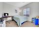 Bright bedroom with neutral walls, a window, and a bed with a blue comforter at 2613 Velodrome Ct, Henderson, NV 89044