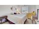 This bright bedroom includes light carpet, a dresser, and warm lamps on the side tables at 2613 Velodrome Ct, Henderson, NV 89044