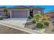 Inviting home featuring a two-car garage and desert landscaping for low maintenance at 2613 Velodrome Ct, Henderson, NV 89044