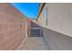 A/C unit on side of house between home and brick fence near gravel at 2613 Velodrome Ct, Henderson, NV 89044