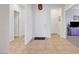 Bright foyer featuring tile flooring, a white front door, and access to various rooms in the home at 2613 Velodrome Ct, Henderson, NV 89044