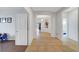 Bright hallway featuring tile floors, white walls, and arched doorways enhance the home's architecture at 2613 Velodrome Ct, Henderson, NV 89044