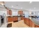 Bright kitchen featuring wooden cabinets, stainless steel appliances, and spacious granite countertops at 2613 Velodrome Ct, Henderson, NV 89044