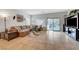 Spacious living room featuring a comfortable sectional sofa and sliding glass door to the backyard at 2613 Velodrome Ct, Henderson, NV 89044