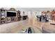 Open concept living and dining area with tile floors, an entertainment center, and kitchen access at 2613 Velodrome Ct, Henderson, NV 89044