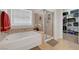 Relaxing main bathroom featuring a soaking tub, glass-enclosed shower, and closet at 2613 Velodrome Ct, Henderson, NV 89044