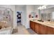 Bright main bathroom with double sinks, walk-in shower, and closet access at 2613 Velodrome Ct, Henderson, NV 89044