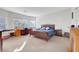 Spacious main bedroom with large windows, a comfortable bed, and a dedicated workspace at 2613 Velodrome Ct, Henderson, NV 89044