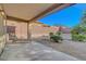 Covered patio with lounging chair overlooking serene, low-maintenance backyard at 2613 Velodrome Ct, Henderson, NV 89044