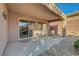 Covered patio with lounging chair overlooking serene, low-maintenance backyard at 2613 Velodrome Ct, Henderson, NV 89044