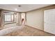 Spacious bedroom featuring plush carpet, natural light, and a walk through to another room at 2832 Cape Hope Way, Las Vegas, NV 89121