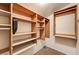 Walk-in closet with custom wood shelving and rods, offering ample storage space at 2832 Cape Hope Way, Las Vegas, NV 89121