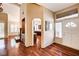 Elegant foyer leading to a living room and kitchen, featuring hardwood floors and natural light at 2832 Cape Hope Way, Las Vegas, NV 89121