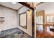 Hallway with decorative tile, archway, and entry to a living room with hardwood floors at 2832 Cape Hope Way, Las Vegas, NV 89121