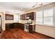 Well-lit kitchen with dark wood cabinets, stainless steel appliances, and hardwood floors at 2832 Cape Hope Way, Las Vegas, NV 89121