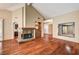 Spacious living room featuring a cozy fireplace, high ceilings, and rich hardwood flooring at 2832 Cape Hope Way, Las Vegas, NV 89121