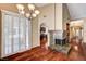 Inviting living room with hardwood floors, stone fireplace, and archway to the kitchen at 2832 Cape Hope Way, Las Vegas, NV 89121