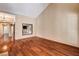 Expansive living room featuring hardwood floors, high ceilings, and a decorative architectural window at 2832 Cape Hope Way, Las Vegas, NV 89121