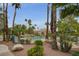 Community pool area features mature landscaping and shade trees, creating a relaxing retreat at 2832 Cape Hope Way, Las Vegas, NV 89121