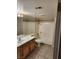 Bathroom with a double sink vanity and a shower over tub, and tile flooring at 2974 Juniper Hills Blvd # 104, Las Vegas, NV 89142