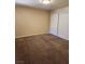 Neutral bedroom featuring beige walls, brown carpet, and a large closet with white doors at 2974 Juniper Hills Blvd # 104, Las Vegas, NV 89142