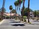 Inviting gated community entrance with lush palm trees and well-maintained landscaping, promoting exclusivity and curb appeal at 2974 Juniper Hills Blvd # 104, Las Vegas, NV 89142