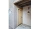 Exterior view of a well-kept condo featuring a beige door and round window near the entrance at 2974 Juniper Hills Blvd # 104, Las Vegas, NV 89142