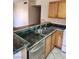 Kitchen featuring stainless steel sink, blue and brown counter tops, and wood cabinets at 2974 Juniper Hills Blvd # 104, Las Vegas, NV 89142
