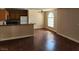 Open concept living room with modern, wood-look floors, and access to kitchen at 2974 Juniper Hills Blvd # 104, Las Vegas, NV 89142