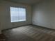 Bright bedroom featuring neutral carpeting, and a large window at 3138 White Rose Way, Henderson, NV 89014